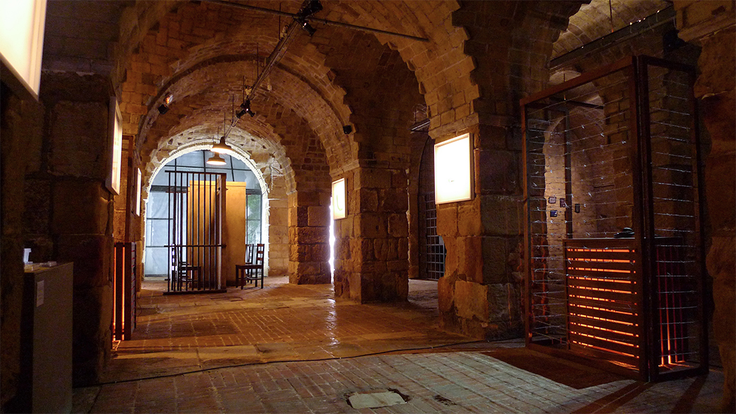 Inside of a stone building, like up warm orange light. 