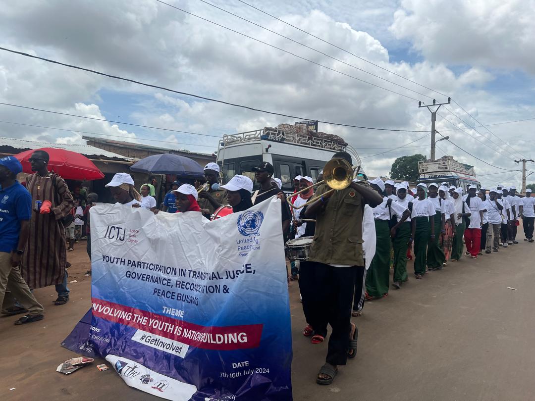 Young people from The Gambia’s Lower River Region march in a caravan-organized parade.