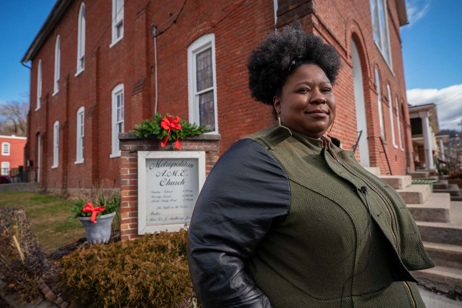 A young woman stands outside a church in Cumberland, MD.