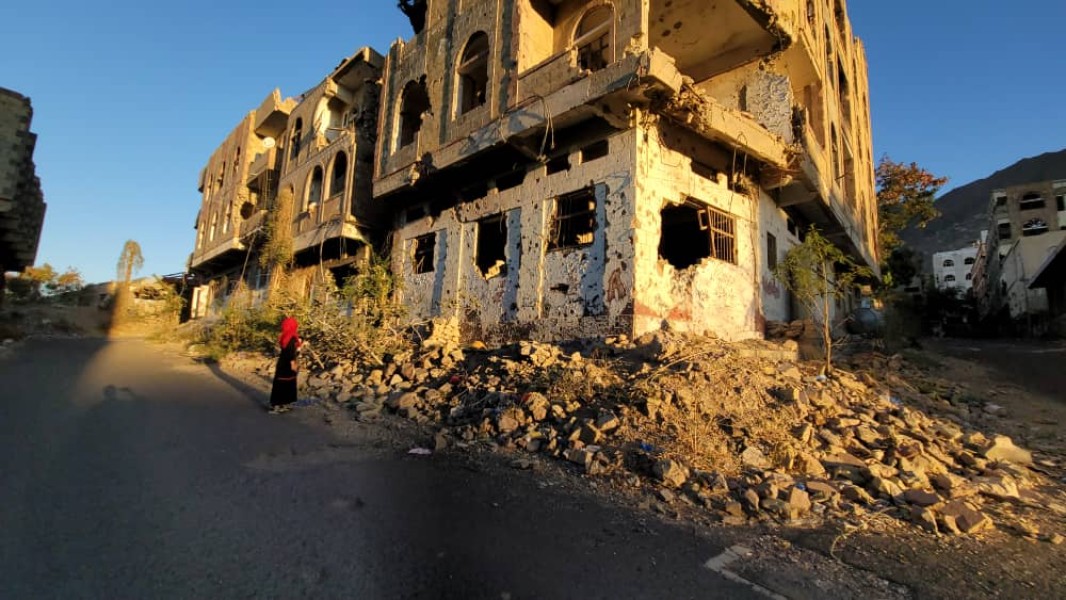 A field monitor from Yemen's National Commission to Investigate Alleged Violations of Human Rights (NCIAVHR) examines destruction caused by the war in the Salah District in Taiz Governorate in 2023. (Maher Al Absi/NCIAVHR)